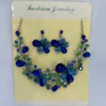 Vista dettagliata del set di gioielli vintage con fiori blu, farfalle e strass lucenti - Blu