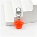 Detail view of the orange jelly star keychain pendant, showing the glossy star and hardware. - Orange