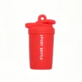 Mini shaker bottle keychain detail view, red fitness gym pendant close-up accessory charm. - Orange