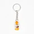 Detailed view of a creative glass drifting bottle keychain with metal ring and pendant. - Orange