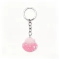 Close-up detail of the cute pink glitter seashell keychain pendant with metal ring and chain. - Pink