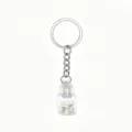 Detailed close-up view of the clear glass drift bottle keychain with mini shell inside. - White