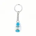 Detailed closeup of a cute drifting bottle keychain pendant with silver metal ring and blue fill. - Blue