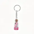 Mini glass wish bottle keychain with pink liquid and rolled note, perfect cute bag charm. - Pink