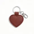 Close-up detail of the brown PU leather heart keychain with metal ring and sturdy clasp. - Coffee