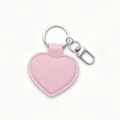 Close-up detail of smooth pink PU leather heart keychain with silver metal ring and clasp. - Pink