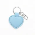 Close up detail of light blue heart PU leather keychain with silver metal ring and clasp. - Blue