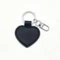 Black heart shaped PU leather keychain detail with metal ring and clasp, smooth gift pendant. - Black