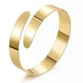 Close-up view of the smooth polished gold finish spiral metal cuff bracelet detailing design. - Narrow Arm Cuff / Middle KC Gold