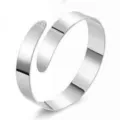 Detailed view of a sleek silver metallic open spiral wrap fashion bracelet accessory. - Narrow Arm Cuff / White K Silver