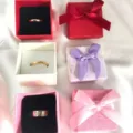 Set of three colorful jewelry gift boxes with ribbons and metal rings for packaging. - Ring Box