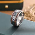 Close-up view of a retro titanium steel ring featuring mechanical gear patterns and wood inlay. - US Size 7 / Gear Ring