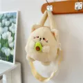 Cute cream-colored plush cat crossbody bag holding an avocado, with a yellow strap. - Avocado Squirrel
