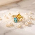 Close-up detail shot of the elegant double-stone gold plated ring with blue and yellow gems. - Birthstone - November