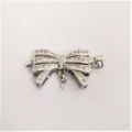 Detail shot of DIY silver tone pave cubic zirconia bow jewelry connector clasp for necklace. - Single Ring Bowknot / Silver