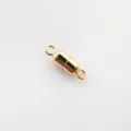 Close-up detail of the gold-plated magnetic jewelry clasp, showing the smooth cylindrical finish. - Gold