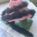 Pink bucket hat adorned with fluffy black feathers, stylish fuzzy design fashion accessory. - Black
