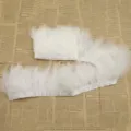 White fluffy feather trim strip for DIY clothing crafts, soft and elegant accessory. - White
