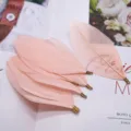 Pink DIY feather accessories with metal clips, soft plumes for handmade jewelry and clothing crafts. - Champagne