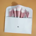 12-piece pink makeup brush set with white storage pouch, essential beauty tool kit. - Twelve Pink Brushes (Wooden Handle) And White Envelope Bag