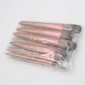 Detailed view of the 12-piece brown makeup brush set in transparent plastic packaging. - 12 Pcs Brown Brushes