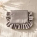 Detailed view of the corduroy ruffle cosmetic pouch, soft texture and cute portable storage design. - Gray