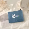 Close-up of cute blue denim pencil case with rabbit print and zipper detail in aesthetic flat lay - Light Blue