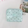 Close-up detail of the light blue polka dot coin purse showing snap button and zipper. - 12*2*9 / Satin Polka Dot / Green