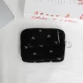 Detailed view of a black mini coin purse with white bow print, flap pocket, zipper, and ring. - 12*2*9 / Satin Bow / Black