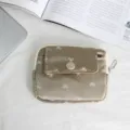 Detailed close-up of a stylish satin coin purse with cute bow print and handy zip closure. - 12*2*9 / Satin Bow / Champagne Gold