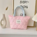 Quilted tote bag detail showcasing the soft pink fabric, blue handles, and brand label. - Quilted Gourd Style / Quilted Pink Body Blue Handle