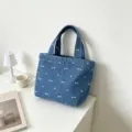 Blue denim tote bag with cute white embroidered bows and heart patterns for daily commute. - Dark Blue Bow