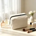 Beige corduroy makeup bag detail, cozy lifestyle display with perfume and brushes. - 18x9x13cm / Off White