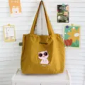 Bonito bolso de lona con cerdo bordado y cordón, gran capacidad para estudiantes y uso diario. - Amarillo jengibre