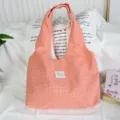 Detailed view of the cozy orange gingham tote bag showcasing soft fabric and cute label. - 43*9*52cm / Orange Grid