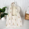 Detailed view of cream fabric hobo bag with cute rabbit print, soft shoulder strap design. - Apricot Floral Rabbit