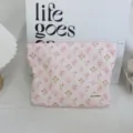 Corduroy floral makeup pouch detail view, showing soft fabric texture and cute pattern. - Pink Grid Floral Cosmetic Bag
