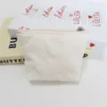 Detail view of a cute quilted bow coin purse in cream, perfect for portable storage. - Cream Bow Embossed