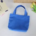 Blue nylon mini tote bag detail showing lightweight waterproof fabric and sturdy handles. - 21*6*27cm / Sapphire Blue