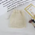 Mesh drawstring storage bag detail showing breathable white fabric for jewelry makeup organization. - 3mm Small Grid