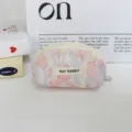 Detail view of cute pink tulip print shell cosmetic pouch with metal zipper and fabric label. - Rabbit Tulip Pink Purple