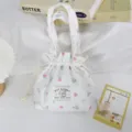 Close-up detail of the floral corduroy drawstring handbag showing soft texture and cute print. - Pink Blue Rose