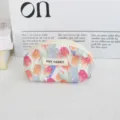 Close-up of the cute tulip print shell cosmetic bag, mini zipper coin purse detail view. - Flower Sea Tulip