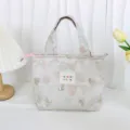 Detailed close-up view of the vintage jacquard lunch bag featuring cute glitter hearts pattern. - Gold Wire Heart