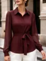 Detailed view of the burgundy striped long sleeve blouse featuring a chic belted waist. - S / Burgundy