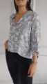Detailed view of a casual long-sleeve floral print blouse featuring a sequin pocket. - S / Tops / Gray