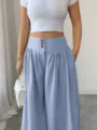 Detailed view of women high-waisted wide-leg casual pants with three-button closure and draped style. - Sky Blue