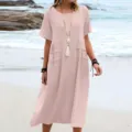 Casual linen beach dress detail, relaxed summer short sleeve midi style in solid pink. - S / Pink