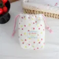 Quilted cotton drawstring pouch with cute strawberry and rabbit print, ideal for camera storage. - Beige