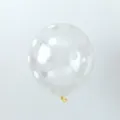 Close-up view of a transparent latex balloon with white polka dot pattern for parties - Transparent with White Polka Dots